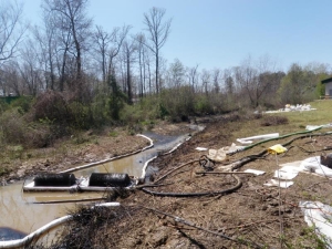Drum skimmers in a creek downstream of the Mayflower oil spill